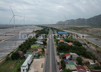 An Aerial Drone footage of windmills along a highway in Vietnam 