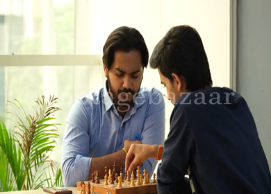 Shot of Indian colleagues playing chess 